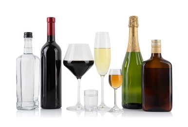 Bottles and glasses with different alcoholic drinks isolated on white