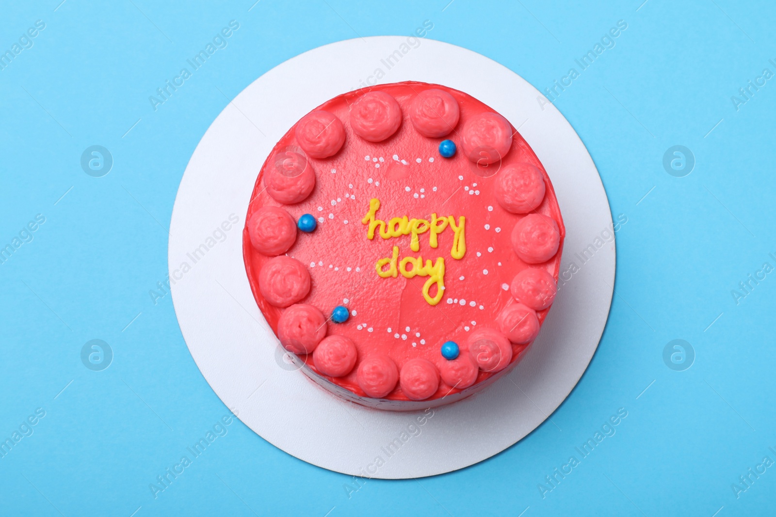 Photo of Cute bento cake with tasty cream on light blue background, top view