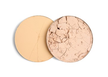 Photo of Different broken face powders on white background, top view