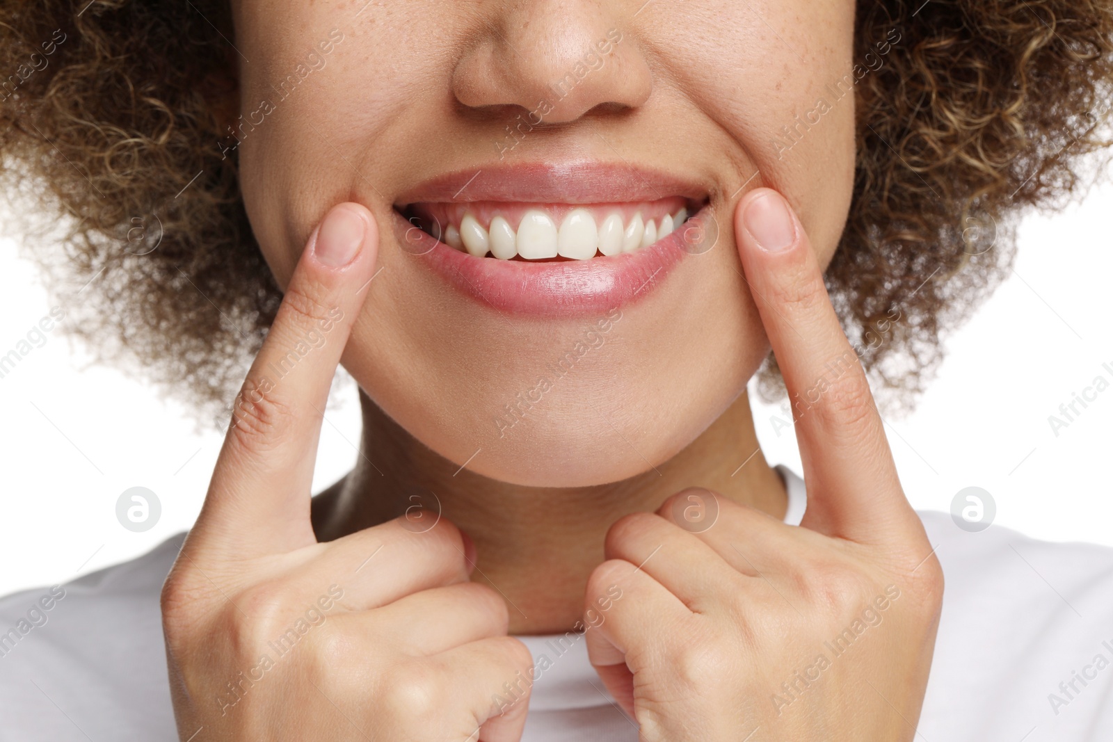 Photo of Woman showing her clean teeth and smiling on white background, closeup