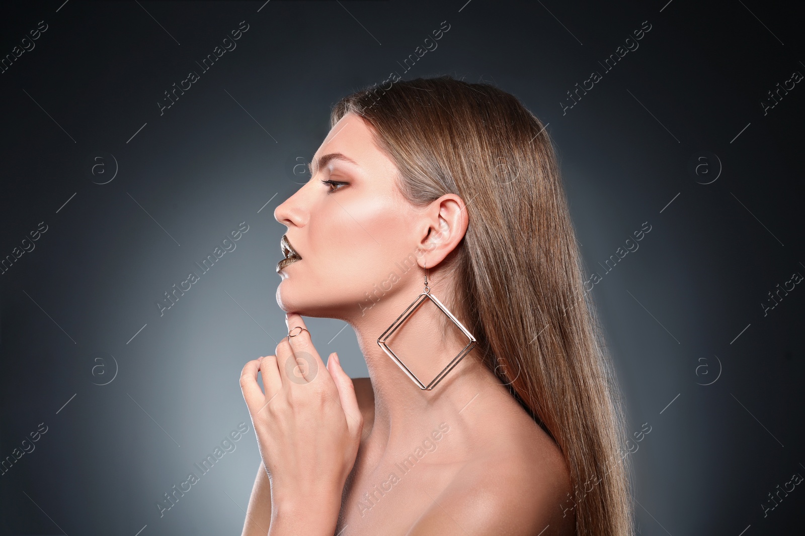 Photo of Portrait of beautiful lady with gold lipstick on grey background