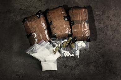 Photo of Composition with hemp in packages on grey  background, top view