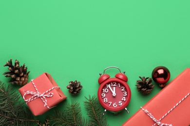 Flat lay composition with alarm clock and gifts on green background, space for text. Boxing day