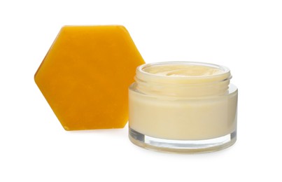 Photo of Cream and natural beeswax on white background