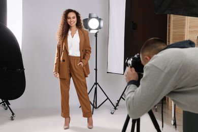 Beautiful African American model posing for professional photographer in studio