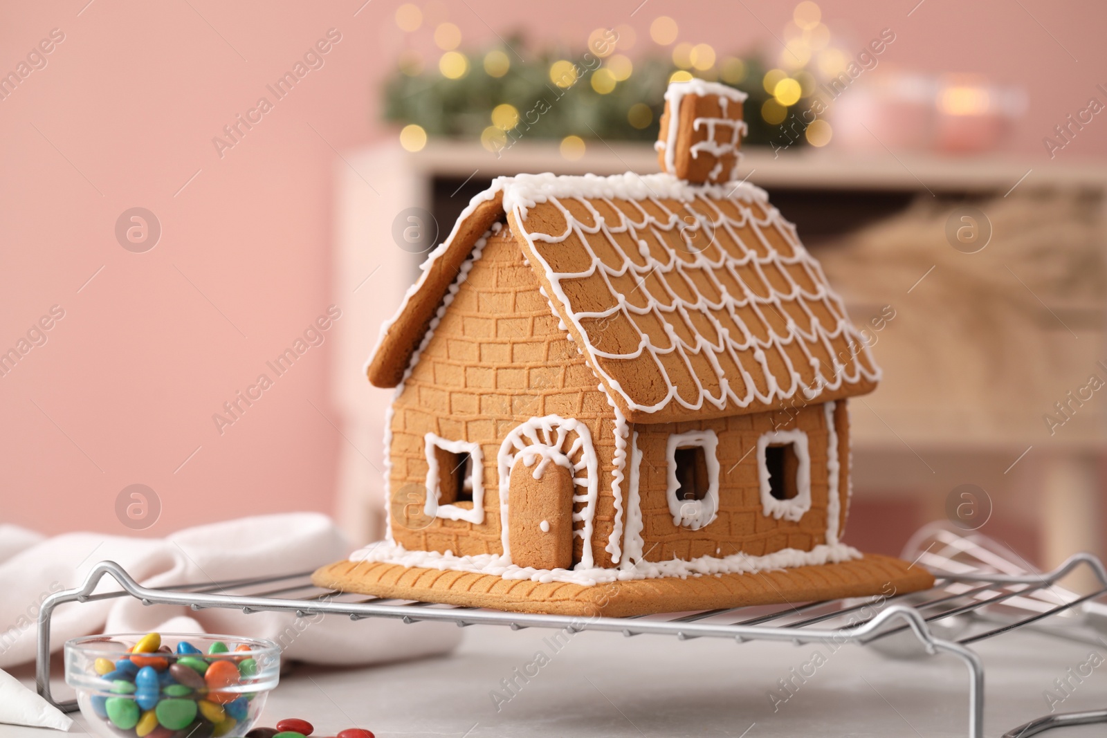 Photo of Beautiful gingerbread house decorated with icing on table