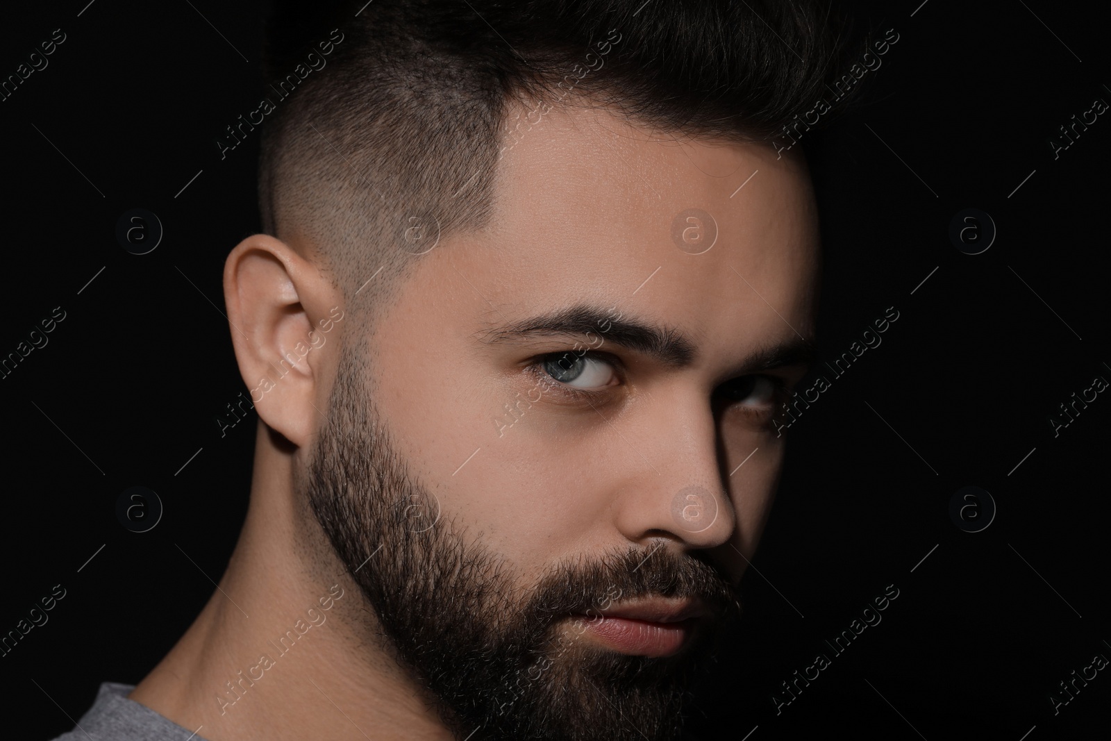 Photo of Evil eye. Man with scary eyes on black background