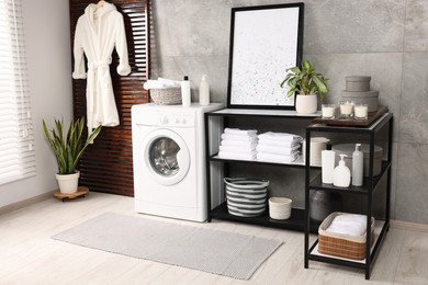 Stylish laundry room with modern washing machine. Interior design