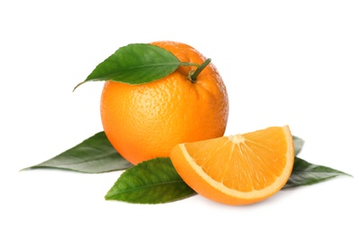 Photo of Cut and whole fresh ripe oranges with green leaves on white background