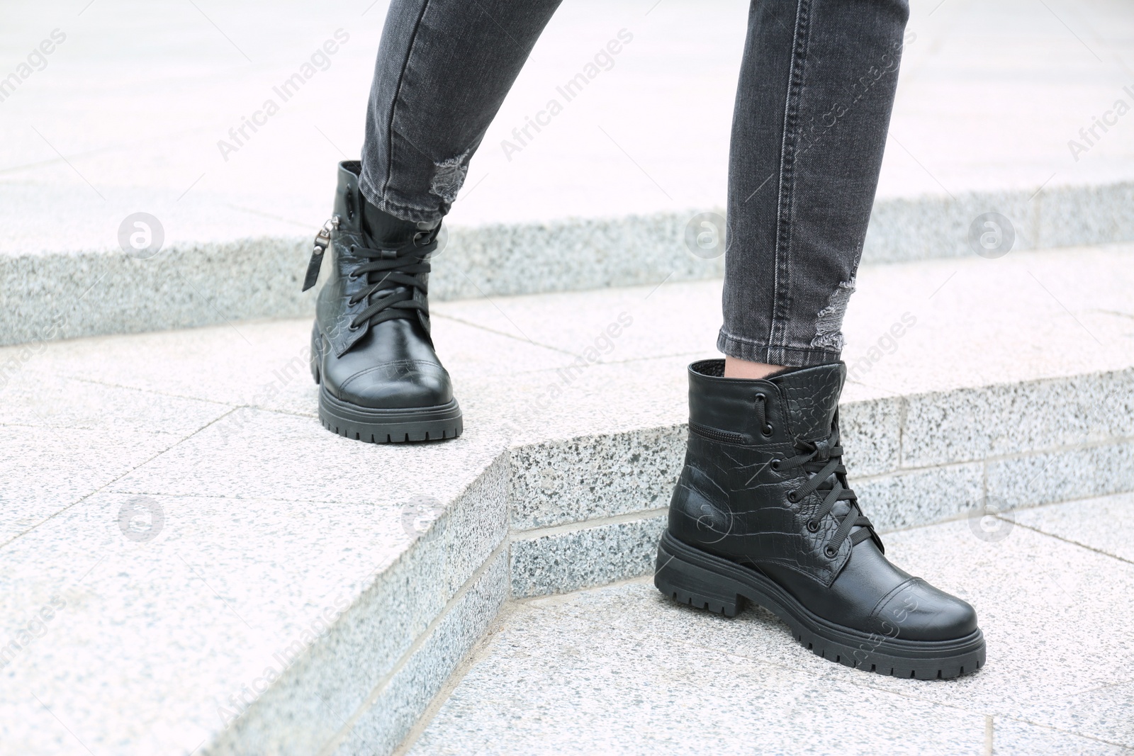 Photo of Woman wearing comfortable stylish boots outdoors, closeup