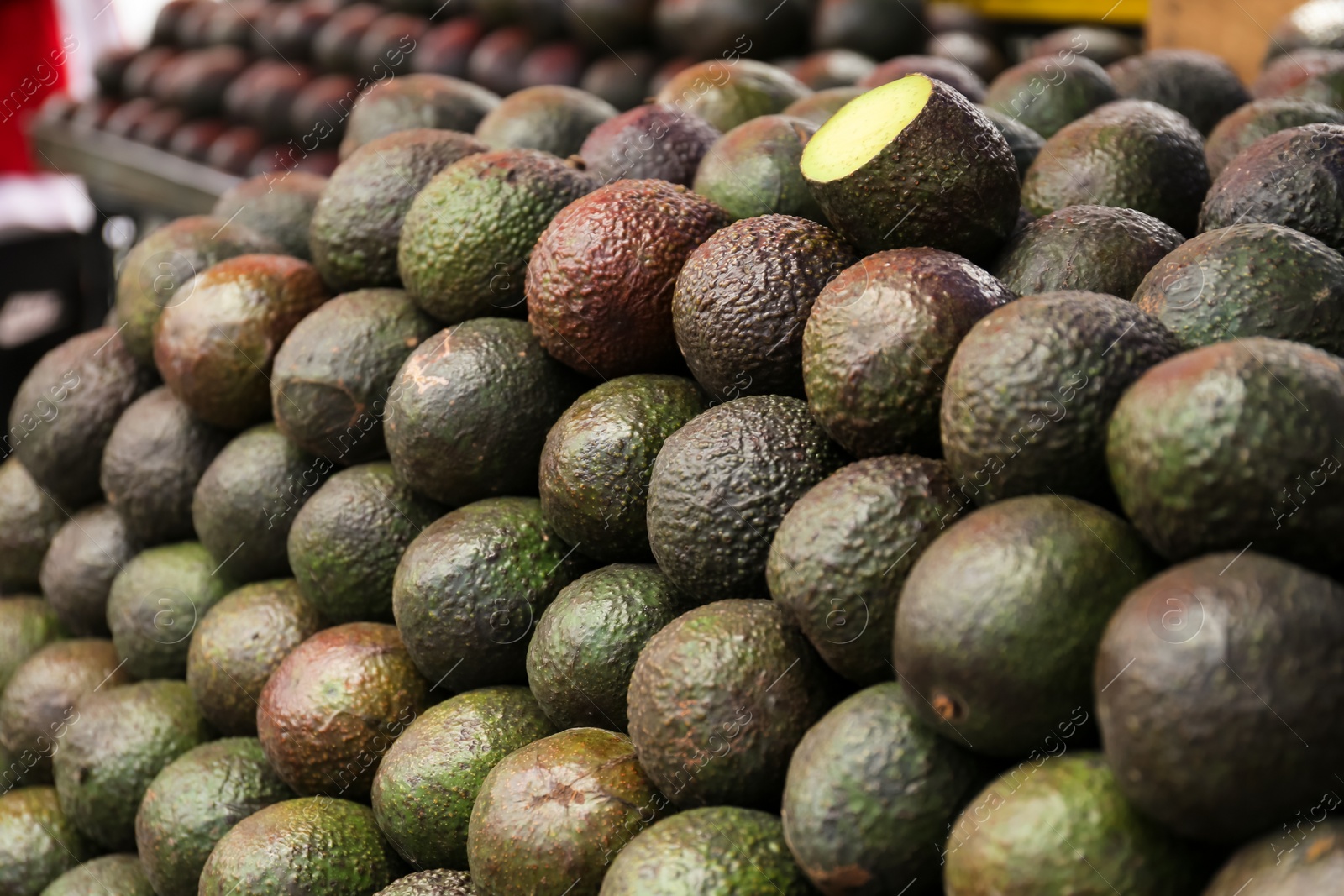 Photo of Pile of delicious fresh ripe avocados at market