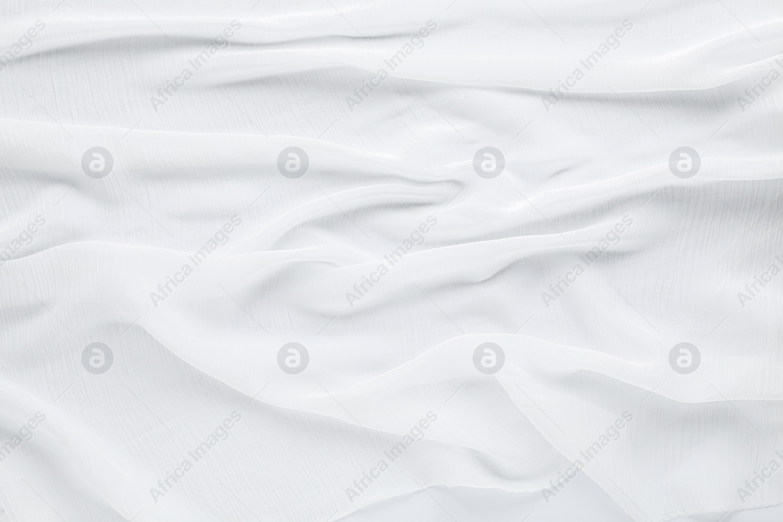 Photo of Beautiful white tulle fabric as background, top view