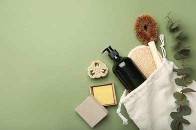 Flat lay composition with eco friendly products on green background, space for text