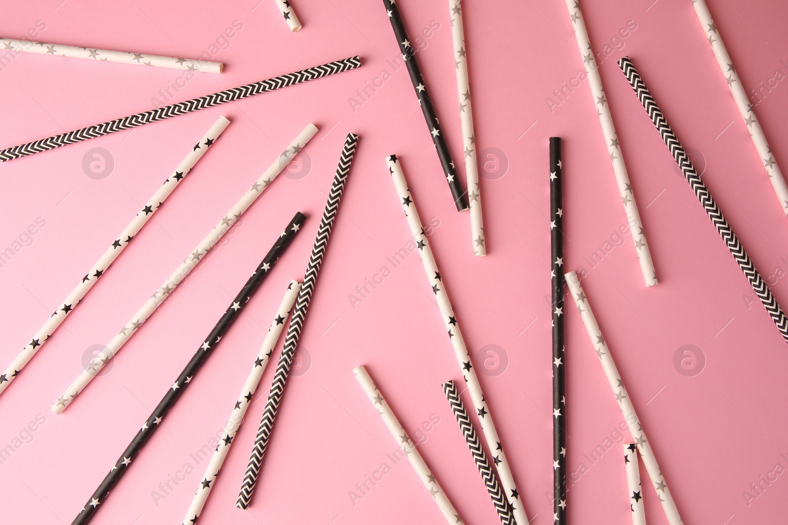 Photo of Many paper drinking straws on pink background, flat lay