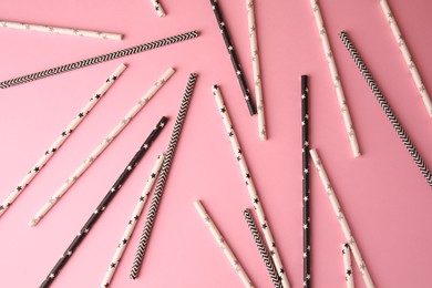 Many paper drinking straws on pink background, flat lay
