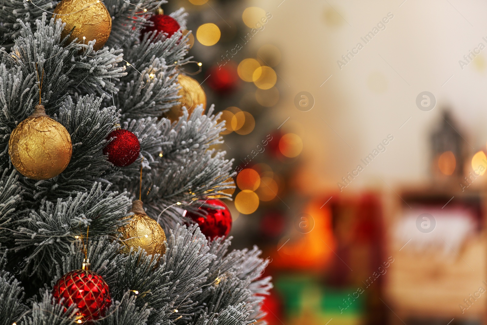 Photo of Beautiful Christmas tree decorated with balls against blurred festive lights, closeup. Space for text