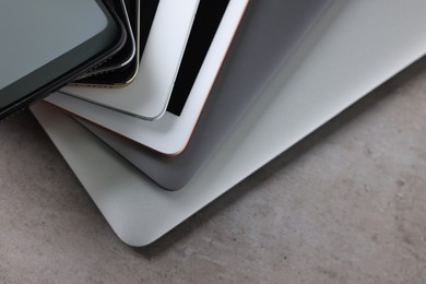 Many different modern gadgets on grey table, closeup