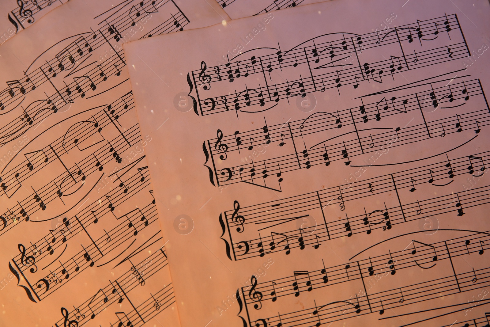 Image of Sheets with music notes as background, top view. Color tone effect