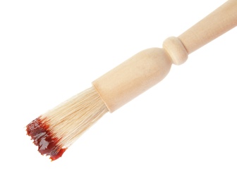 Photo of Basting brush with barbecue sauce on white background