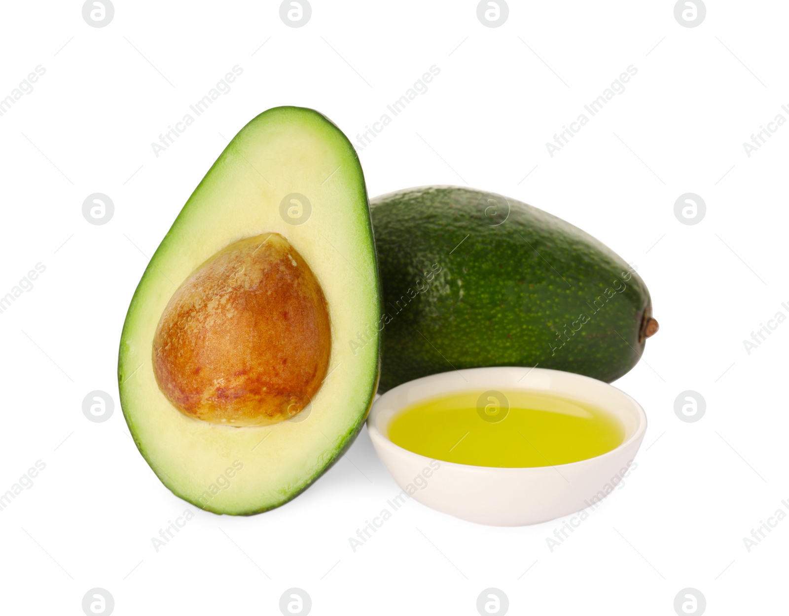 Photo of Cooking oil and fresh avocados isolated on white