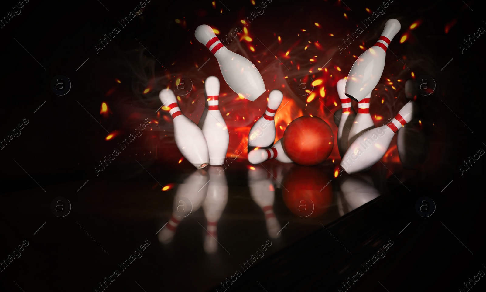 Image of Bowling ball bouncing pins with fire. Successful hit - strike