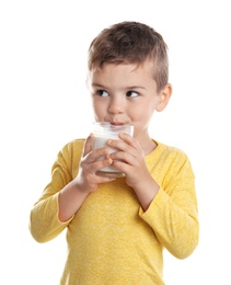 Photo of Cute little boy drinking milk on white background