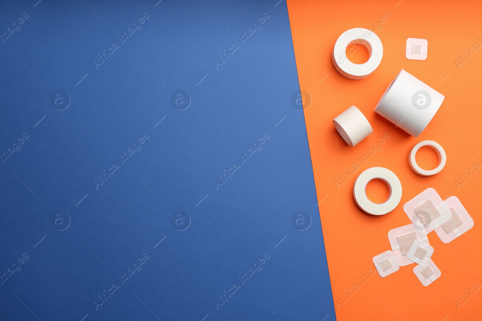 Photo of Different types of sticking plasters on color background, flat lay. Space for text
