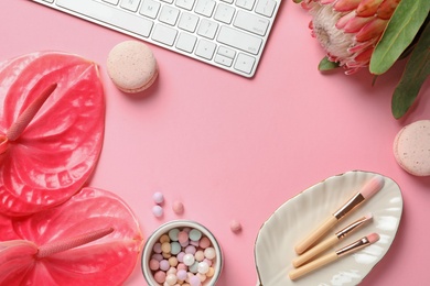 Creative flat lay composition with tropical flowers, computer keyboard and beauty accessories on color background