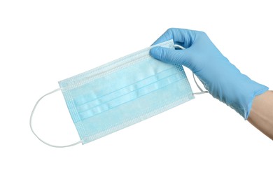 Photo of Doctor in latex gloves holding medical mask on white background, closeup