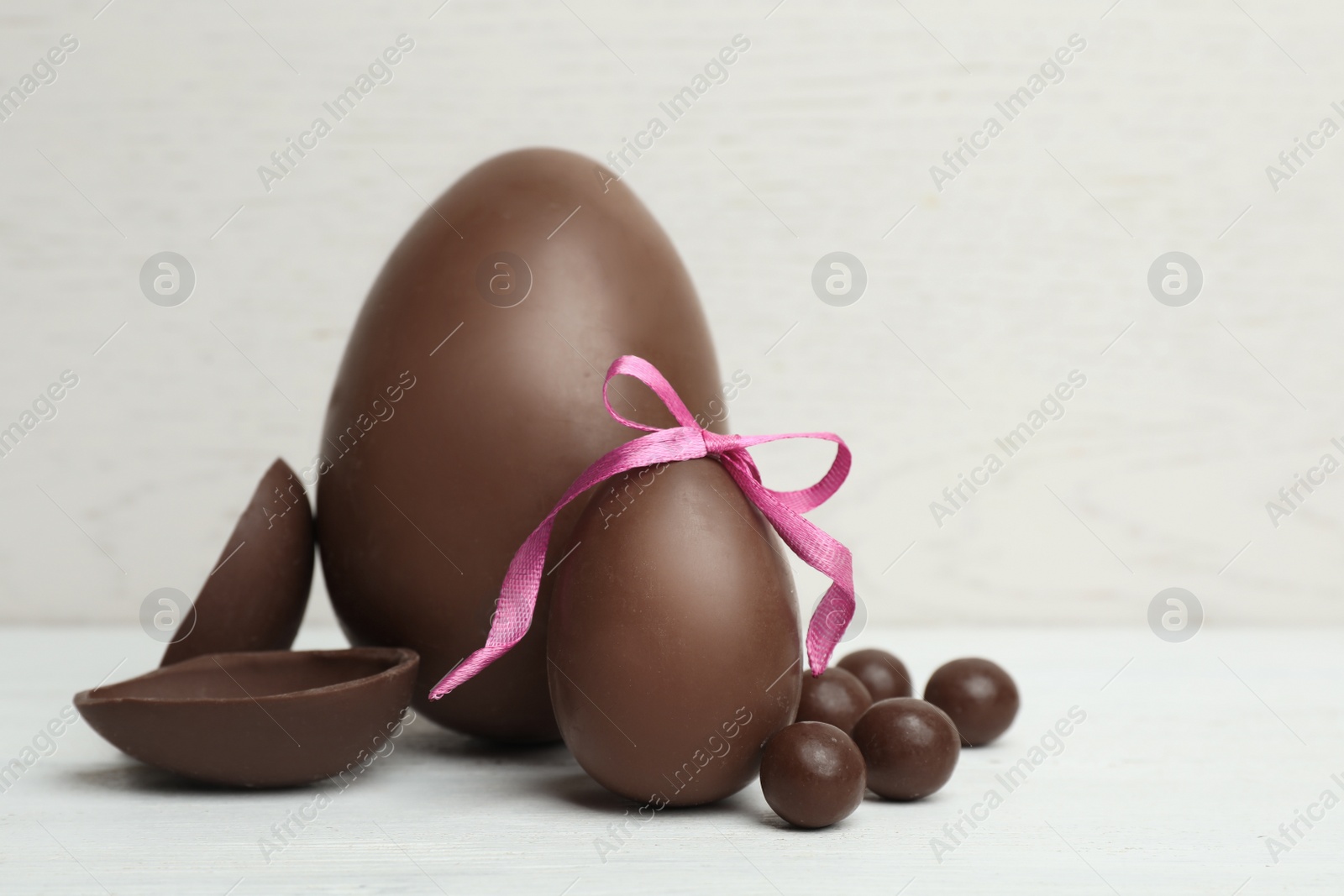 Photo of Composition with chocolate Easter eggs on table. Space for text