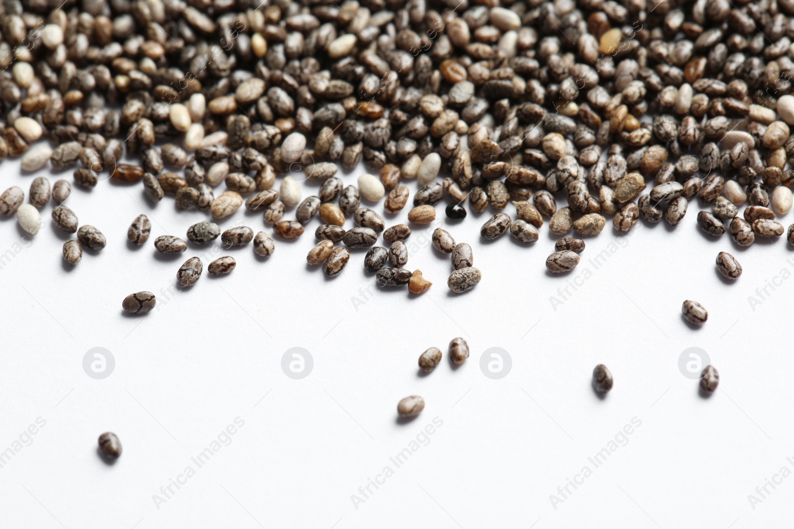 Photo of Chia seeds scattered on white background. Organic superfood