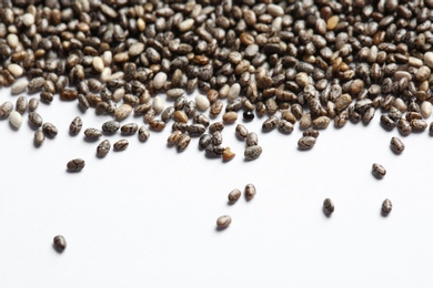 Photo of Chia seeds scattered on white background. Organic superfood