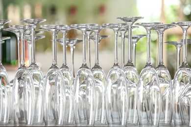 Photo of Empty glasses on wooden table against blurred background