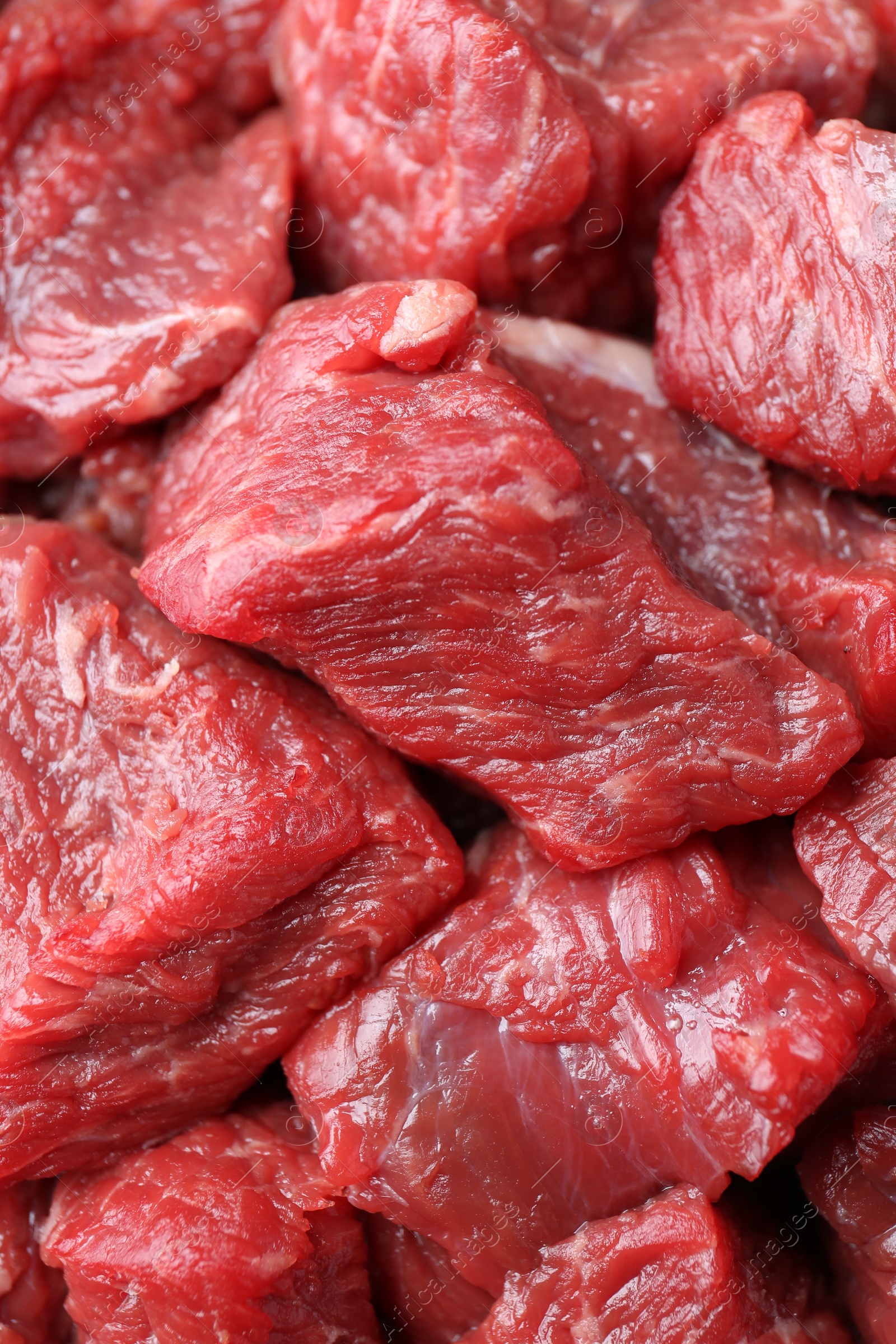 Photo of Pieces of raw beef meat as background, closeup