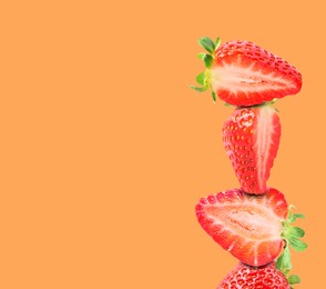 Image of Stack of fresh strawberries on orange background, space for text