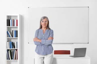 Portrait of professor near whiteboard in classroom