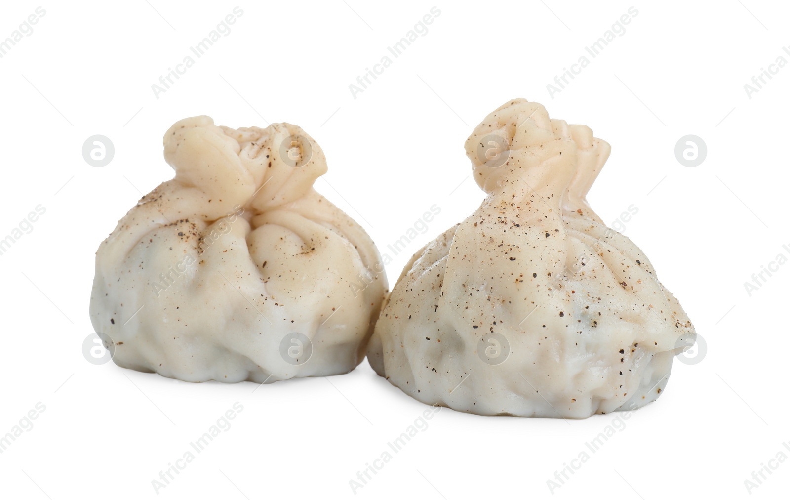 Photo of Two tasty khinkali (dumplings) and spices isolated on white. Georgian cuisine