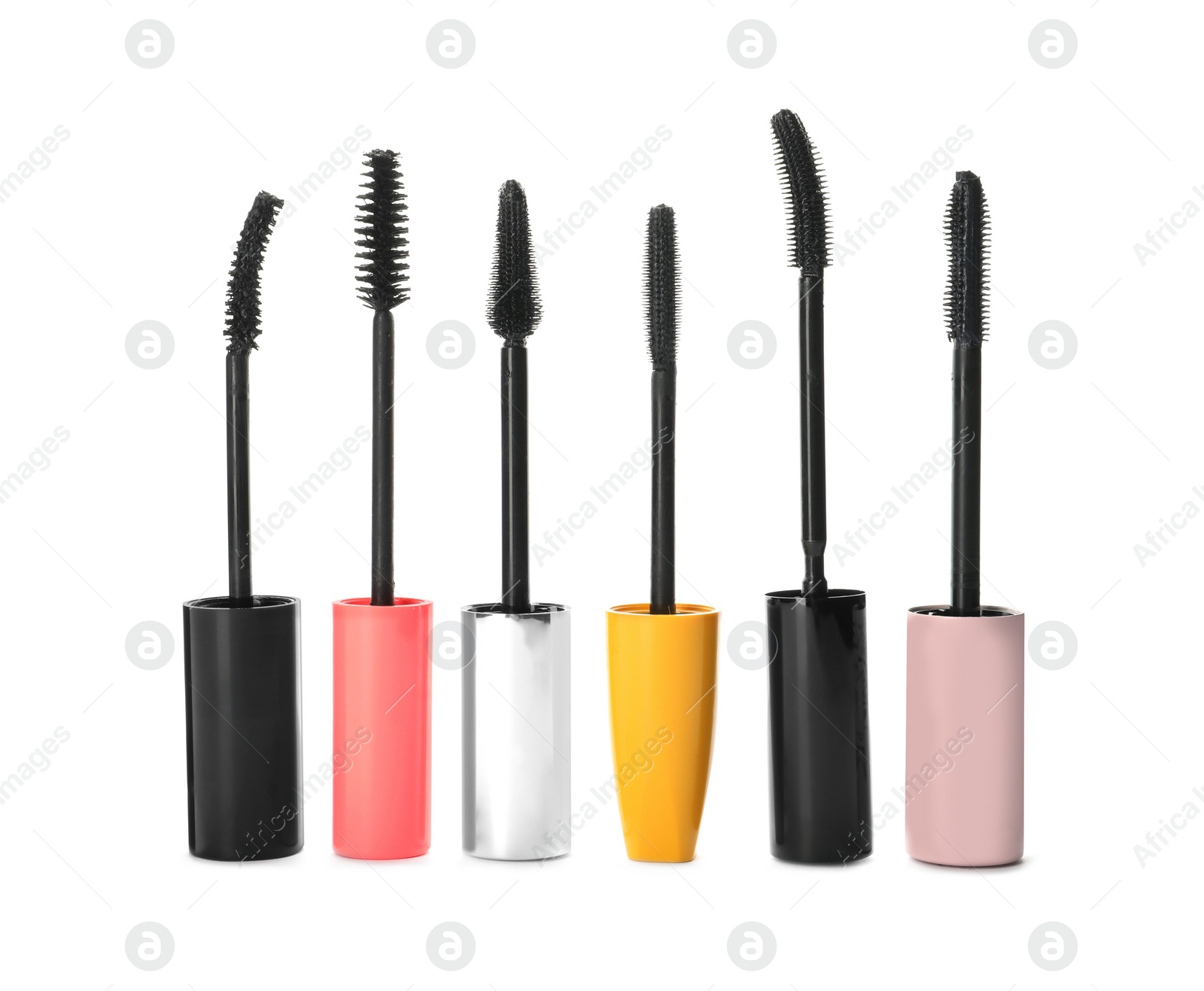 Photo of Many mascara wands for eyelashes on white background. Makeup product