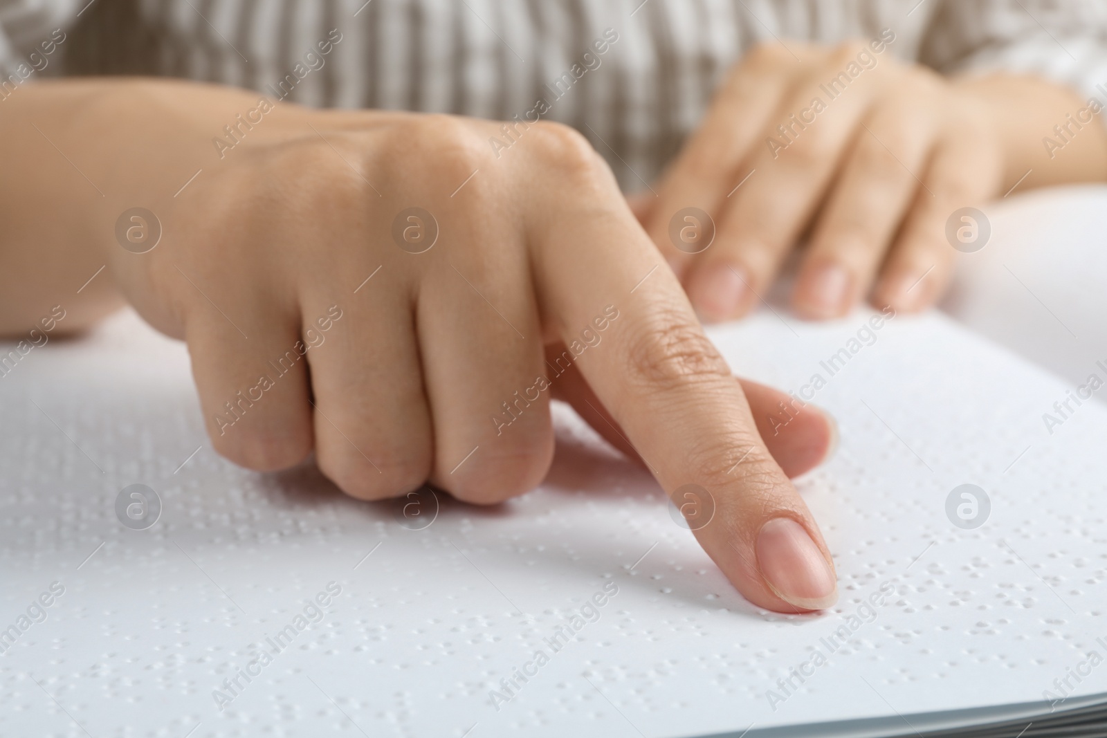 Photo of Blind person reading book written in Braille, closeup