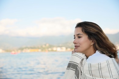 Photo of Portrait of beautiful young woman near sea. Space for text