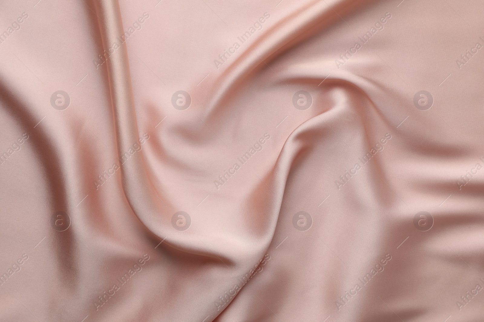 Photo of Crumpled pink silk fabric as background, top view