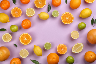 Photo of Flat lay composition with tangerines and different citrus fruits on lilac background. Space for text