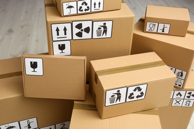 Photo of Cardboard boxes with different packaging symbols. Parcel delivery