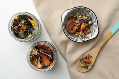 Photo of Different dry herbs and tea on white background, flat lay