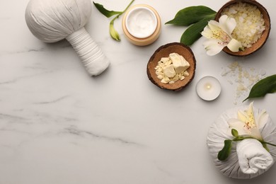 Photo of Flat lay composition with spa products and flowers on white marble table. Space for text