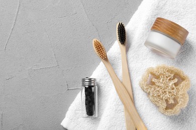 Photo of Flat lay composition with bamboo toothbrushes on light grey table. Space for text