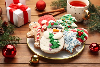 Photo of Delicious homemade Christmas cookies and festive decor on wooden table