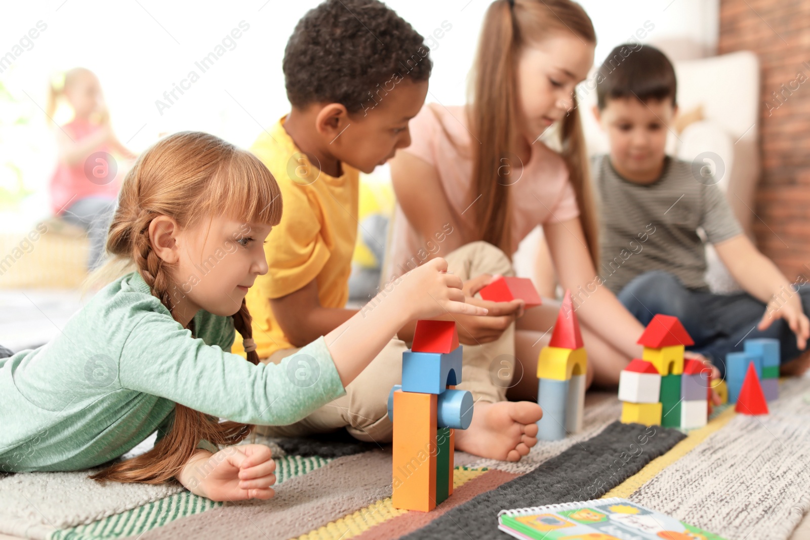 Photo of Cute little children playing together indoors