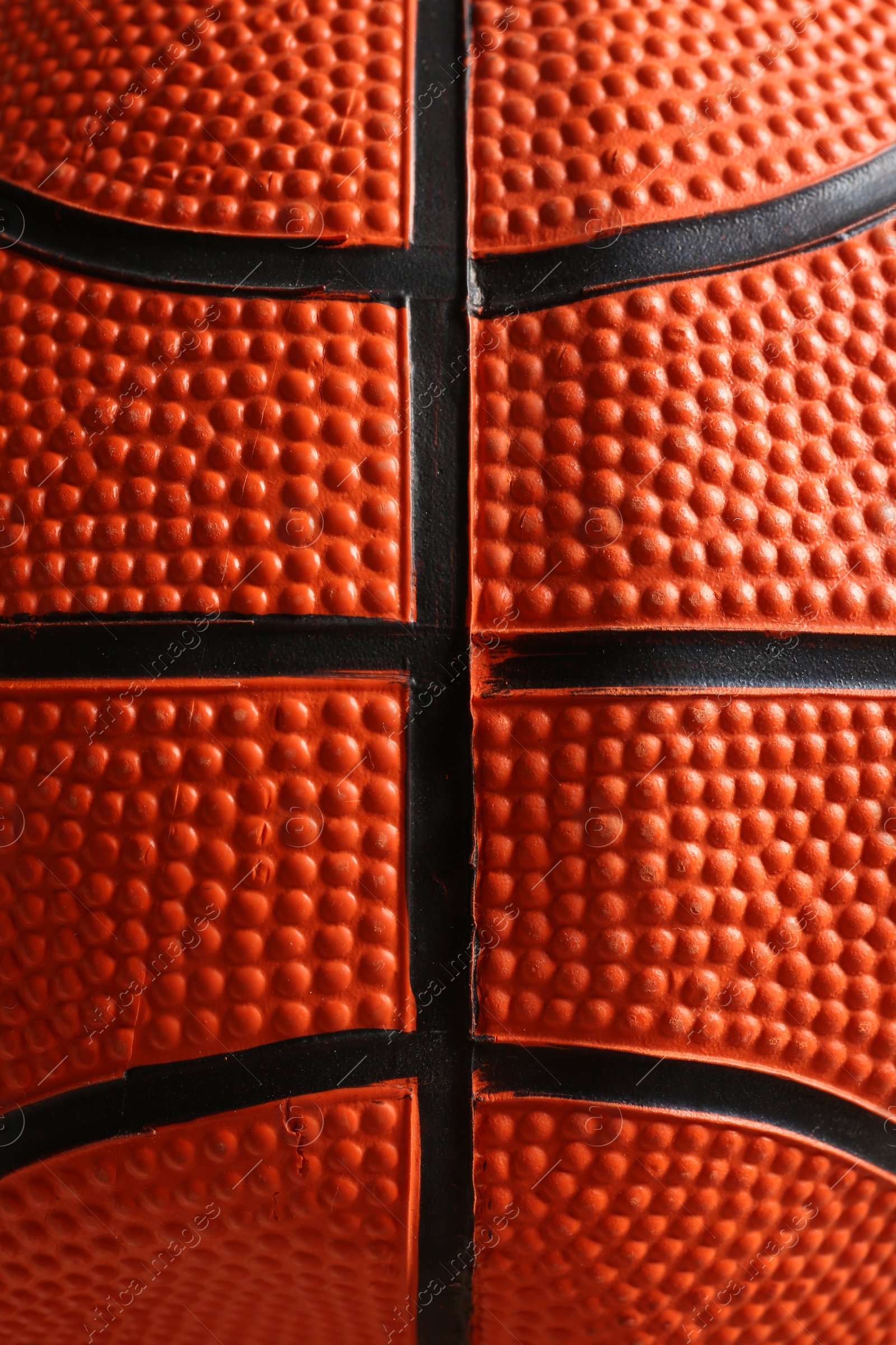Photo of Texture of orange basketball ball as background, closeup view