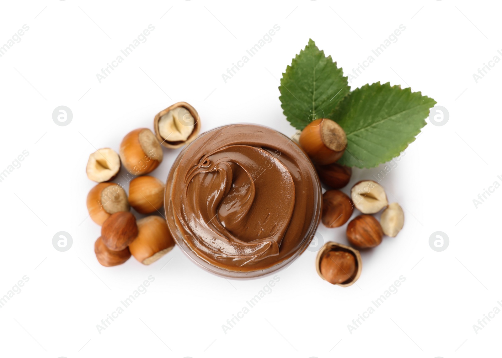 Photo of Tasty chocolate hazelnut spread and nuts on white background, top view